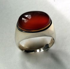 Summer Rain This is a statement sterling silver ring with an oval, rustic orange carnelian set in a rose gold bezel. R2237-1. © 2011-2015 Artisanimpact Inc. All rights reserved. Construction & Dimensions: Materials: sterling silver, 10k rose gold, carnelian Approximate top of the ring: 13mm (0.51in) x 18mm (0.70in) We can make any size, including quarter sizes. Please choose your size in the drop down menu, when you check out. About our jewelry Artisanimpact features a variety of brass, silv Hippie Ring, Two Tone Ring, Hippie Rings, Oxidized Silver Rings, Carnelian Ring, Boho Chic Jewelry, Summer Rain, Carnelian Stone, Gold And Silver Rings