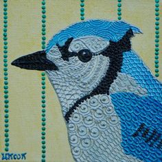 a blue bird is painted on a piece of fabric with beaded trimmings