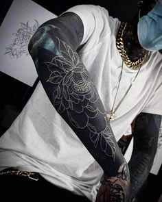 a man with tattoos on his arm and arms