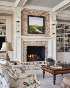 a living room filled with furniture and a fire place under a painting on the wall