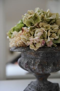 a vase filled with flowers sitting on top of a table