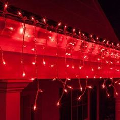 red lights are hanging from the side of a building