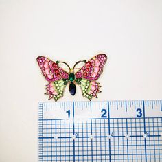 Super colorful pink and green rhinestone enamel butterfly brooch. Add something cute and sparkle to your favorite outfit. Not intended for children ages 13 and under. Also, for many items we can accommodate large orders, so please send us a message. Multicolor Butterfly Brooches As Gift, Butterfly-shaped Enamel Pin Gift, Pink Enamel Pins As Gifts, Butterfly Shaped Enamel Pin For Gifts, Pink Enamel Pins For Gifts, Pink Enamel Pins As Gift, Pink Rhinestone Brooches As Gift, Pink Rhinestone Brooches For Gifts, Multicolor Rhinestone Brooches As Gifts