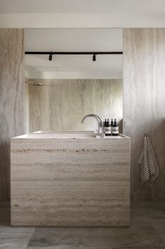 a bathroom with a sink, mirror and towel rack