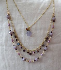 "Gold tone three strands necklace. Inside strand has a purple natural pear shape gem. Second and third strands have light purple and dark shiny mystic color purple beads. Length Shortest :15.5\", Longest : 20\" Extension : 2.5\"" Purple Handmade Double Strand Necklace, Pink Bead Necklace, 2024 Jewelry, Three Strand Necklace, Purple Beads, Art Necklaces, Pink Beads, Jewelry Diy, Strand Necklace