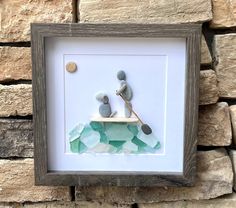 a photo frame with some rocks in it