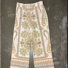 Zara Light Tan Beige Pants With Light Blue, Yellow, Burnt Orange, Khaki Green Paisley Print Pattern. Wide Leg, Side Zipper. New With Tags Ladies Xs Measures 14.5 Inches Across Waist 11 Inches Across Pant Bottom 29 Inch Inseam 40.5 Inches Top To Bottom Length Material 55% Linen, 45% Cotton Summer Wide-leg Paisley Print Pants, Chic Patterned Bottoms With Floral Print, Chic Floral Print Patterned Bottoms, Spring Patterned Wide Leg Printed Pants, Casual Boho Print Pants For Spring, Paisley Print Trousers For Spring, Stretch Paisley Print Bottoms For Summer, Fitted Beige Floral Print Bottoms, Patterned Printed Straight Pants