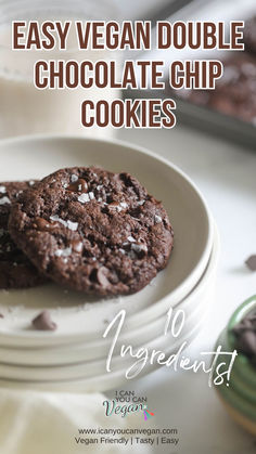 two chocolate chip cookies sitting on top of each other in front of a plate with the words easy vegan double chocolate chip cookies