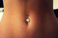 a woman's stomach with a flower pin on it