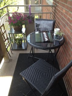 a table and chair sitting on a balcony