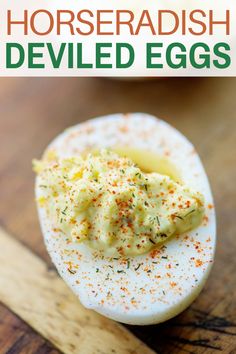 deviled eggs on a wooden cutting board with text overlay that reads, how to make deviled eggs horseradish deviled eggs