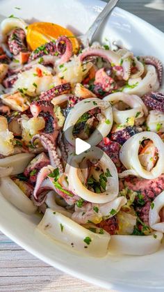 an octopus salad is served in a white bowl