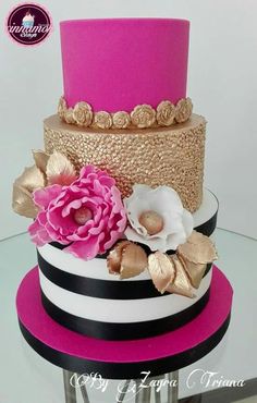 a three tiered cake with pink and black flowers on it's top layer