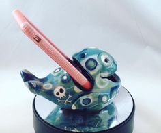 a toothbrush in a holder with skulls and bones on it's head,