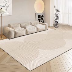 a living room with white furniture and wooden floors