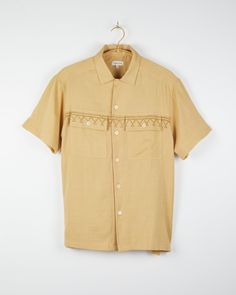 The Harshil is a relaxed fitting camp collar shirt with two oversized patch front pockets and corozo buttons. Referencing a Lippan wall art, a simple border stripe print was designed and printed using traditional hand block printing. Printed on our naturally dyed cotton silk base using a combination of natural dyes. - 100% Handwoven cotton- Naturally dyed- Standard fit- Spread collar- Two oversized patch chest pockets with button-through flaps- Clean front placket- Bone buttons- Straight bottom Relaxed Fit Camp Shirt With Patch Pockets, Beige Relaxed Fit Camp Shirt With Pockets, Relaxed Fit Shirt With Patch Pockets And Johnny Collar, Relaxed Fit Shirt With Flap Pockets And Camp Collar, Camp Shirt With Welt Pockets And Camp Collar, Beige Camp Shirt With Relaxed Fit And Camp Collar, Relaxed Fit Camp Shirt With Welt Pockets, Hand Block Printing, Line Drying