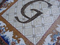 the letter q is made up of different colored tiles and designs on top of each other