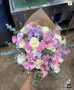 a person holding a bouquet of flowers in their hand