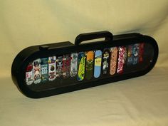 a black case filled with skateboards on top of a white sheet covered flooring