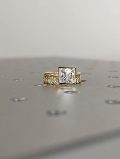 a diamond ring sitting on top of a table