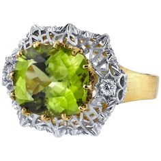 A velvety, grass-green, cushion-cut peridot is showcased in this beautiful, Florentine style ring. The center peridot is set horizontally, surrounded by an intricately-pierced, white gold design that sits atop a brushed finished yellow gold band. Fine, brilliant cut diamonds add even more sparkle and elegance to this one-of-a-kind ring. Handmade in 18k yellow and white gold by our artisans in Italy. Peridot, 12.15 x 10.71mm, 5.70 carats Round brilliant cut diamonds, .20 carat total Ring size 7 C Peridot Jewelry, Diamond Fashion Rings, White Diamond Ring, Gold Cocktail Ring, Diamond Jewelry Designs, Green Diamond, Enamel Ring, Green Peridot, Green Enamel