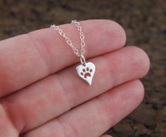 Heart shaped paw print charm necklace in by jersey608jewelry Horn Pendant Necklace, Paw Print Charm, Moon Pendant Necklace, Dog Jewelry, Swarovski Necklace, Cat Paw, Cat Jewelry, Rhinestone Designs, Crystal Necklace Pendant