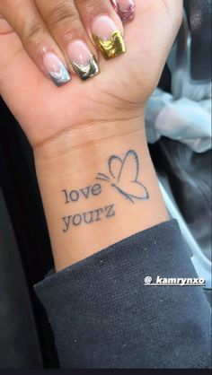 a woman's wrist tattoo with the words love yourz on it