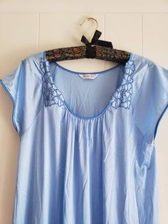 This is a vintage Vanity Fair night gown. It has short sleeves. It is light blue. There are 2 floral appliques. It is a long gown and is marked a size medium. (I know this is wrinkled, but it has been in a trunk for over 30 years. This was made in the USA. The measurements are as follow: (All measurements taken flat) Armpit to armpit: 21 inches Waist: 26.5 inches Hips: 29 inches Length from back: 51 inches This may seem too big for a size medium, but it is meant to be loose. Don't forget to stop Blue Short Sleeve Nightgown For Bedtime, Light Blue Lace Trim Nightgown For Home, Vintage Light Blue Summer Nightgown, Blue Vintage Cotton Nightgown, Vintage Light Blue Sleepwear With Lace Trim, Vintage Vanity Fair, Women's Nightgowns, Vintage Vanity, Floral Applique