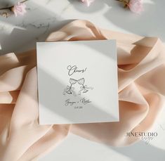 a close up of a greeting card on a table with flowers in the back ground