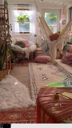 an image of a living room with hammock hanging from the ceiling and rugs on the floor