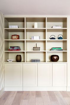 a white bookcase with many books on it