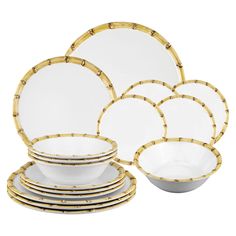 a set of white and gold dinnerware