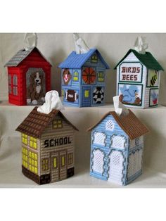 four small houses made out of crochet are shown in different colors and sizes