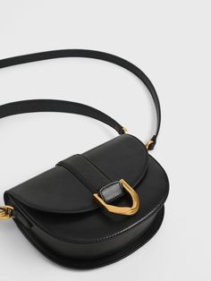 Black Gabine Saddle Bag Classic Crossbody Saddle Bag With Gold-tone Hardware, Chic Black Saddle Bag With Metal Hardware, Classic Office Saddle Bag With Metal Hardware, Chic Saddle Bag With Turn-lock Closure And Top Handle, Chic Everyday Saddle Bag With Brass Hardware, Chic Saddle Bag With Brass Hardware For Everyday, Modern Saddle Bag With Gold-tone Hardware For Work, Chic Workwear Saddle Bag With Turn-lock Closure, Timeless Saddle Shoulder Bag With Gold-tone Hardware