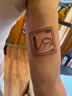 a woman's arm with a stamp on it that says, i love the mountains