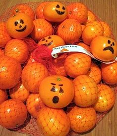 an image of oranges with faces drawn on them and the caption says cute idea always looking for party ideas that don't involve candy draw jack - lantern faces