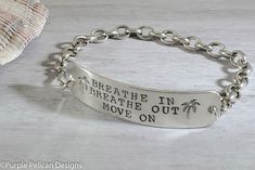 "This bracelet is hand stamped with \"Breathe In Breathe Out Move On\". A great reminder to relax and take life as it comes. The tag with the wording measures approximately 1/2\" x 2\" and the entire bracelet comes in your choice of 6\", 7\", or 8\". Stylish hook clasps on the side making it super easy to put on and take off with one hand. Other lengths available as well, just write me a note at checkout if you need a different size. Made from solid .925 sterling silver. Want to say something el Spiritual Hand Stamped Silver Bracelets, Adjustable Hand Stamped Name Bracelet, Everyday Spiritual Engraved Bracelets, Breath In Breath Out, Hook Clasp, Silver Chain Bracelet, Chain Bracelet, Sterling Silver Chains, Hand Stamped