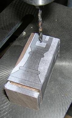 a piece of metal being worked on with a drill bit in it's center