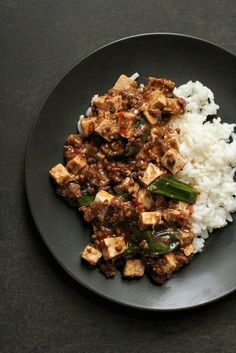 a plate with rice, meat and vegetables on it