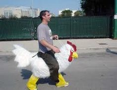 a man riding on the back of a white chicken