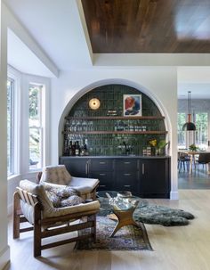 a living room filled with furniture next to a window covered in lots of light wood