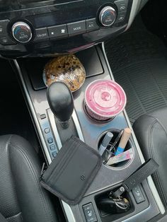 the interior of a car with various items on the dash board and steering wheel controls