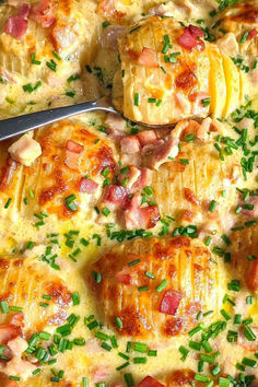 a casserole dish with ham, cheese and green onion garnishes