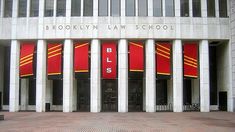 the front entrance to brooklyn law school with red banners