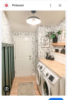 a room with a washer and dryer in it, next to a door