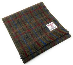 Authentic Harris Tweed Scarf - in a Green Tartan Design Handwoven in the Outer Hebrides of Scotland This beautiful Harris Tweed Scarf is made from 100% pure virgin wool and is handwoven in the Outer Hebrides of Scotland. It is the perfect accessory for any occasion, and is sure to keep you warm and stylish all winter long. The scarf is approximately 59 inches long and 9.8 inches wide, and features a fringed edge. It is made from a blend of colours that is both stylish and classic, and is sure to complement any outfit. Harris Tweed is a registered trademark and is protected by law. It is the only fabric in the world that is governed by its own Act of Parliament. This ensures that Harris Tweed is made to the highest standards of quality and craftsmanship. When you buy a Harris Tweed scarf, y Tweed Scarf, Harris Tweed Fabric, Baker Boy Hat, Green Tartan, Outer Hebrides, Tartan Scarf, Scarf Handmade, Tartan Design, Unique Nature