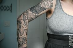 a woman with tattoos on her arm and arms