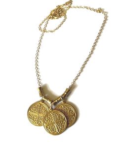 Triple Byzantine Brass Token Necklace with hourglass bead accents on 14K gold-filled chain.  This is a really unique and fun necklace. It has a whimsical charm and is easy to wear with most anything.  Please contact me with any questions. If you require specific measurements, please don't hesitate to ask.  I hope you love your item(s) as much as I loved making it. Please don't hesitate to reach out to me if you have any special requests or alterations. I am happy to make changes to pieces in my store to suit your needs so long as I am capable of doing so. Shipping will take place within approximately 3 business days. All sales are final, HOWEVER, if the item is not as described, has flaws that hinder its functionality or breaks within the first 30 days, I will be happy to repair or replace Gold Brass Necklaces For Blessing, Gold Brass Necklace For Blessing, Gold Brass Necklace For Blessings, Brass Byzantine Necklace Perfect For Gifts, Bohemian Gold Charm Necklaces For Good Luck, Bohemian Gold Charm Necklace For Good Luck, Gold Byzantine Brass Necklace, Gold Amulet Charm Necklaces For Blessings, Gold Nickel-free Charm Necklaces For Good Luck