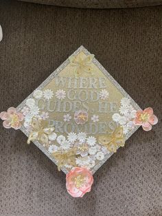 there is a graduation cap with flowers on it that says where god's he comes