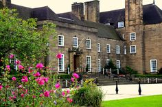 a large building with flowers in front of it